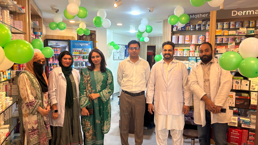Pharmacy team celebrating Pakistan Independence Day on 14 August with green and white decorations.